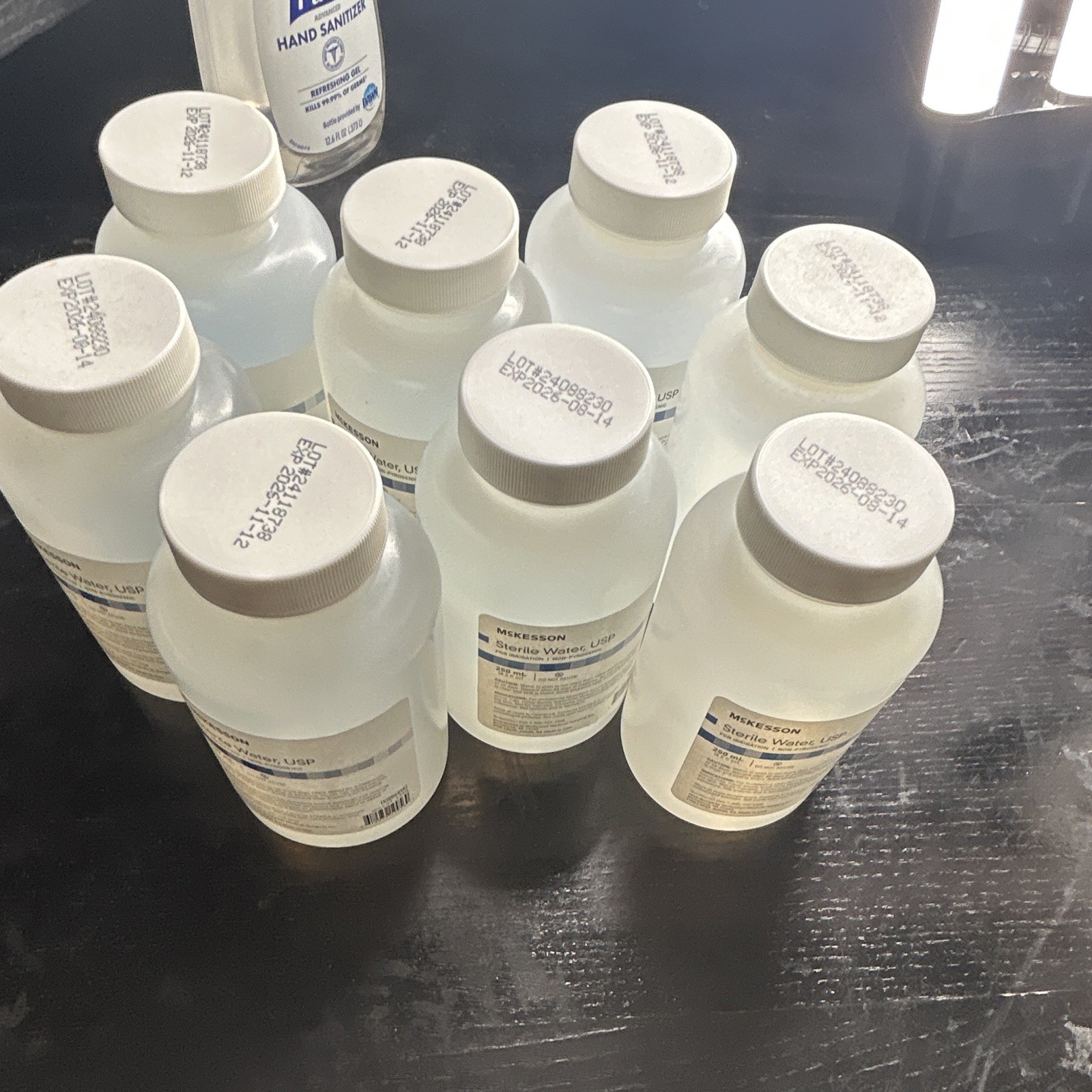 7 count of McKesson Sterile Water USP 250 mL Bottles for Medical Laboratory Use